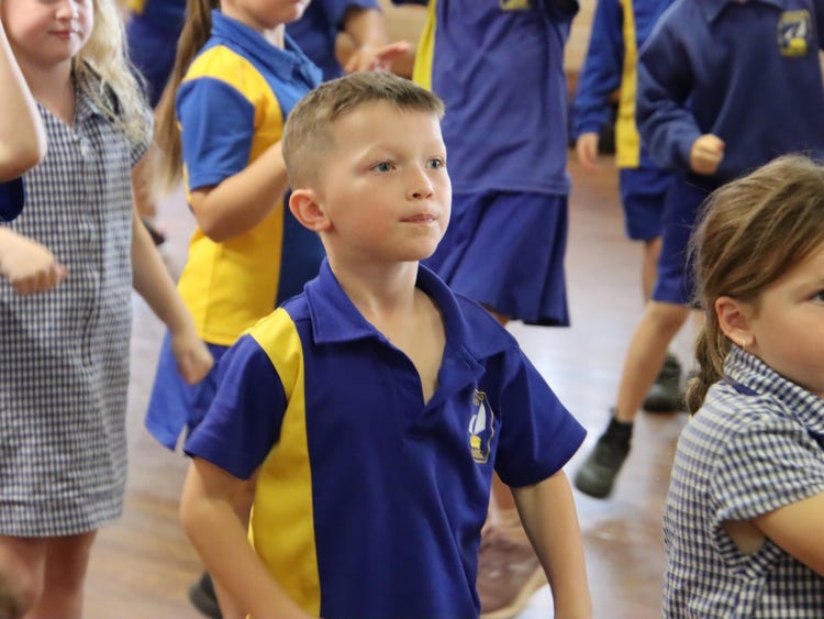 Multiple students playing a sports game wearing the LAPS summer uniform.
