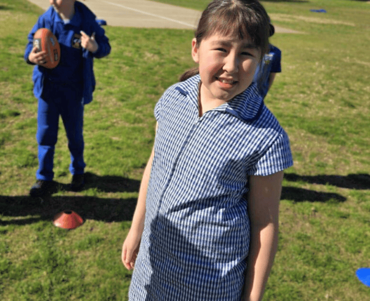 One student looking face-on wearing the LAPS summer dress.